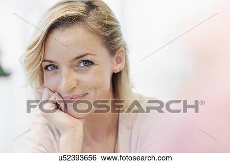 Portrait of mid adult woman with hand on chin View Large Photo Image Stock Photograph - Portrait of mid adult woman with hand on chin. Fotosearch