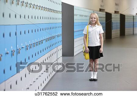 Stock Image - Portrait of schoolgirl in corridor. Fotosearch
