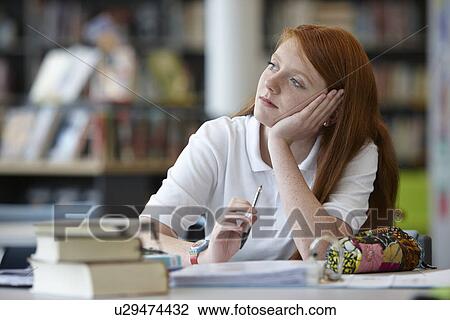 Portrait of teenage girl daydreaming in library View Large Photo Image Stock Image - Portrait of teenage girl daydreaming in library. Fotosearch