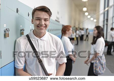 Stock Photo - Portrait of teenage schoolboy in corridor. Fotosearch