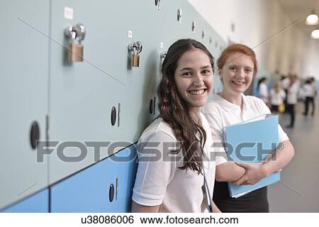 Stock Photograph - Portrait of teenage schoolgirls in corridor. Fotosearch