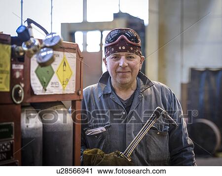 Portrait of welder in overalls and safety goggles in factory View Large Photo Image Stock Image - Portrait of welder in overalls and safety goggles in factory. Fotosearch