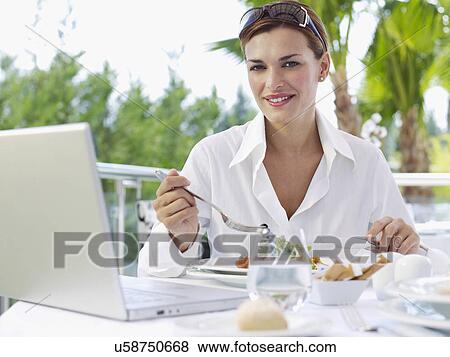 Portrait of young businesswoman having working lunch View Large Photo Image Stock Photo - Portrait of young businesswoman having working lunch. Fotosearch