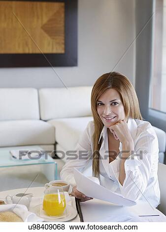 Portrait of young businesswoman working in hotel room View Large Photo Image Stock Photo - Portrait of young businesswoman working in hotel room. Fotosearch