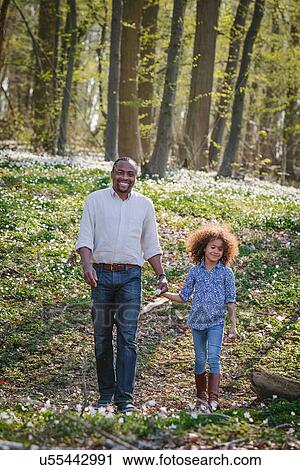 Portrait of young girl and father walking in woods View Large Photo Image Stock Image - Portrait of young girl and father walking in woods. Fotosearch