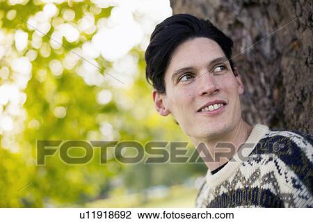 Portrait of young man looking away View Large Photo Image Stock Image - Portrait of young man looking away. Fotosearch