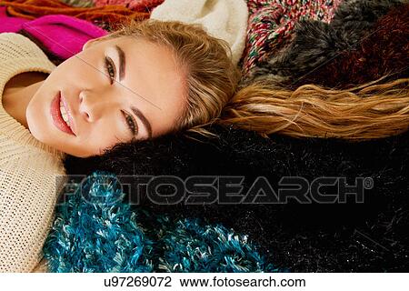 Portrait of young woman lying on furry blanket View Large Photo Image Stock Image - Portrait of young woman lying on furry blanket. Fotosearch