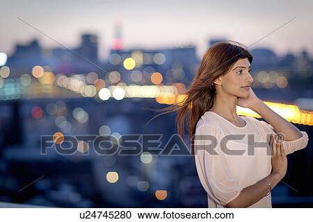 Portrait of young woman on rooftop View Large Photo Image Stock Image - Portrait of young woman on rooftop. Fotosearch