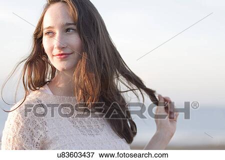Stock Photo - Portrait of young woman on vacation, Whitstable, Kent, UK. Fotosearch