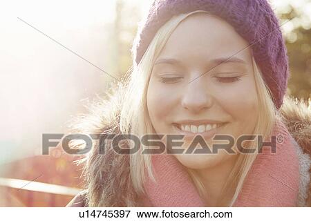 Portrait of young woman wearing knit hat, eyes closed View Large Photo Image Stock Photo - Portrait of young woman wearing knit hat, eyes closed. Fotosearch