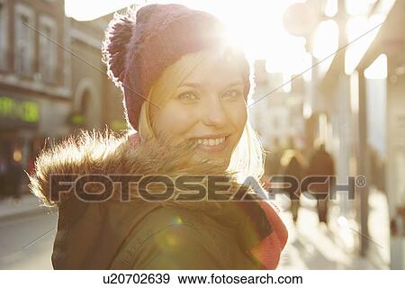 Portrait of young woman wearing knit hat, looking over shoulder View Large Photo Image Stock Photo - Portrait of young woman wearing knit hat, looking over shoulder. Fotosearch