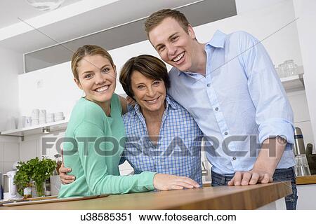 Stock Image - Portrait of youthful grandmother with adult grandchildren. Fotosearch
