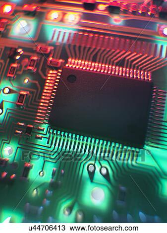 Stock Image - Printed Circuit Board. The central processing unit interprets and executes software instructions. Fotosearch