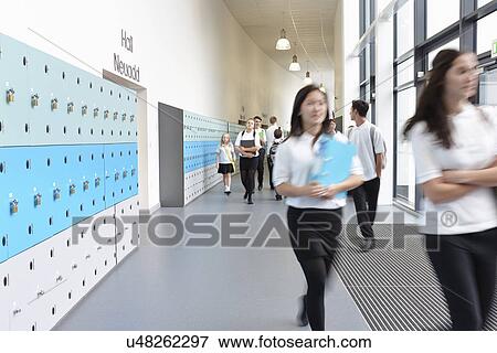 Schoolchildren walking through school corridor View Large Photo Image Stock Photo - Schoolchildren walking through school corridor. Fotosearch