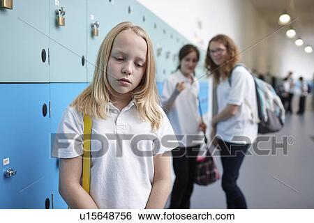 Schoolgirl being bullied in school corridor View Large Photo Image Stock Photograph - Schoolgirl being bullied in school corridor. Fotosearch