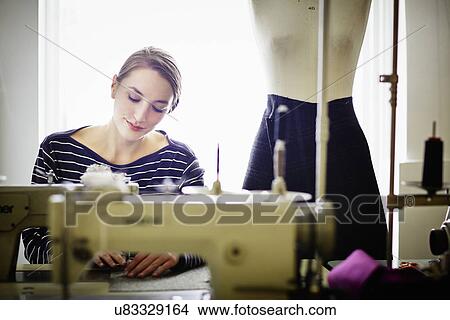 Picture - Seamstress working at sewing machine. Fotosearch