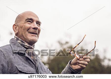 Senior man gesturing with spectacles View Large Photo Image Stock Image - Senior man gesturing with spectacles. Fotosearch