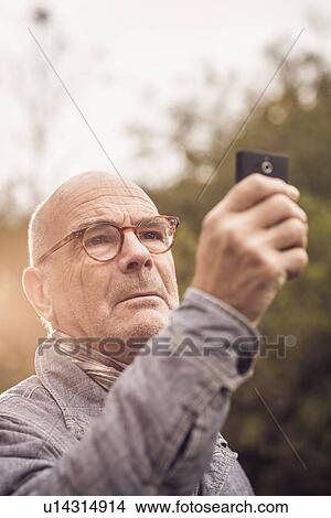 Senior man using cellular phone View Large Photo Image Picture - Senior man using cellular phone. Fotosearch