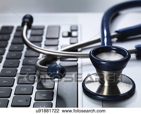 Stethoscope sitting on laptop illustrating online healthcare and doctor's desk View Large Photo Image Stock Image - Stethoscope sitting on laptop illustrating online healthcare and doctor's desk. Fotosearch