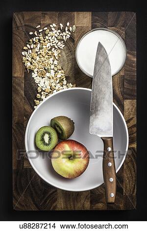 Still life of apple and kiwi fruit in bowl with yogurt and oats View Large Photo Image Picture - Still life of apple and kiwi fruit in bowl with yogurt and oats. Fotosearch
