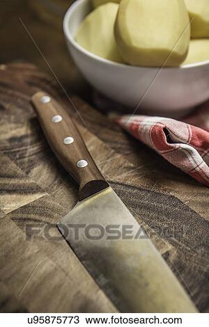 Still life of peeled potatoes in bowl and kitchen knife View Large Photo Image Stock Image - Still life of peeled potatoes in bowl and kitchen knife. Fotosearch