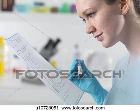 Technician holding blood sample in clinical laboratory with test results View Large Photo Image Stock Image - Technician holding blood sample in clinical laboratory with test results. Fotosearch