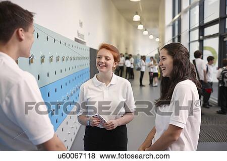 Stock Photo - Teenagers chatting in school corridor. Fotosearch