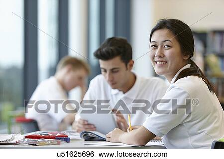 Teenagers working in school classroom View Large Photo Image Stock Photograph - Teenagers working in school classroom. Fotosearch