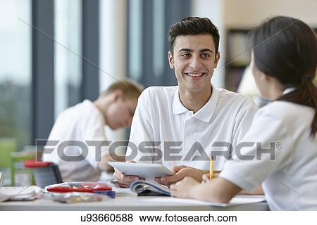 Teenagers working together in school classroom View Large Photo Image Stock Photo - Teenagers working together in school classroom. Fotosearch