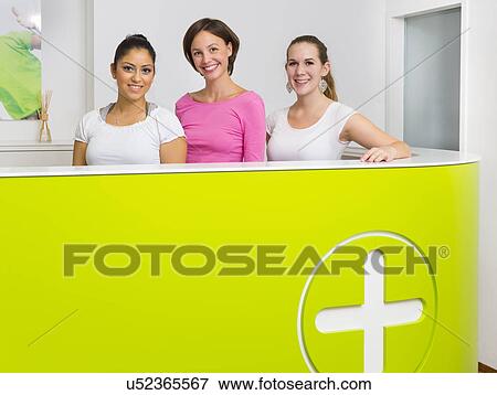 Three female receptionists at desk View Large Photo Image Stock Photo - Three female receptionists at desk. Fotosearch