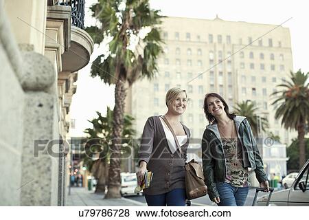 Two female friends pulling suitcases, Cape Town, South Africa View Large Photo Image Stock Photo - Two female friends pulling suitcases, Cape Town, South Africa. Fotosearch