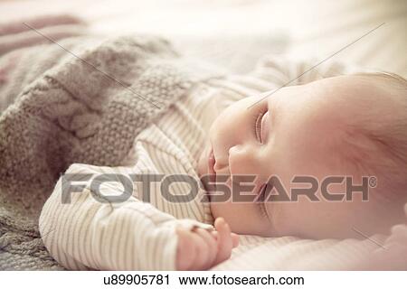 Two month old baby boy asleep in crib View Large Photo Image Stock Image - Two month old baby boy asleep in crib. Fotosearch
