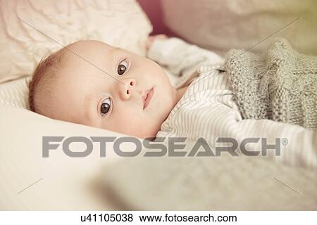 Two month old baby boy lying awake in crib View Large Photo Image Stock Photo - Two month old baby boy lying awake in crib. Fotosearch