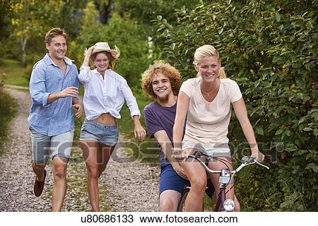 Two young couples chasing each other on bicycle, Gavle, Sweden View Large Photo Image Stock Image - Two young couples chasing each other on bicycle, Gavle, Sweden. Fotosearch