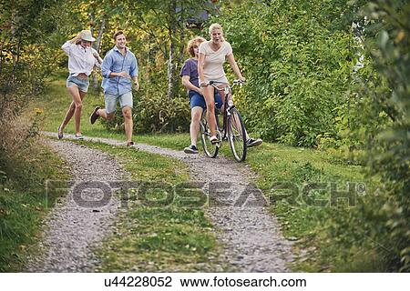 Two young couples chasing each other along dirt track, Gavle, Sweden View Large Photo Image Stock Image - Two young couples chasing each other along dirt track, Gavle, Sweden. Fotosearch