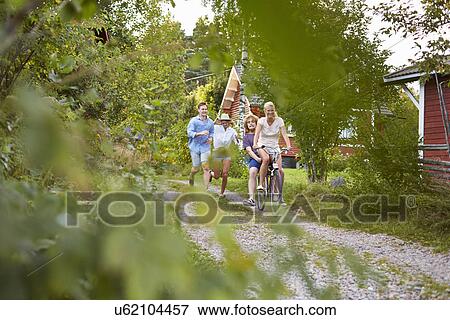 Stock Photo - Two young couples chasing each other, Gavle, Sweden. Fotosearch