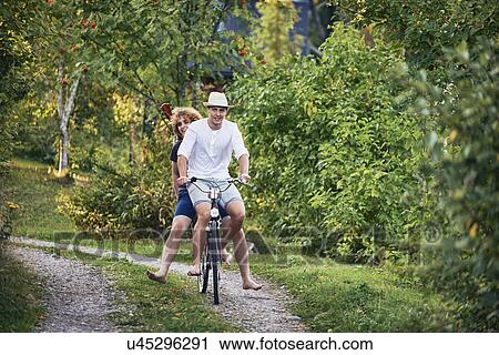 Two young men riding bicycle barefoot, Gavle, Sweden View Large Photo Image Stock Image - Two young men riding bicycle barefoot, Gavle, Sweden. Fotosearch