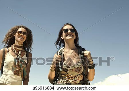 Two young women carrying backpacks, Cape Town, South Africa View Large Photo Image Picture - Two young women carrying backpacks, Cape Town, South Africa. Fotosearch