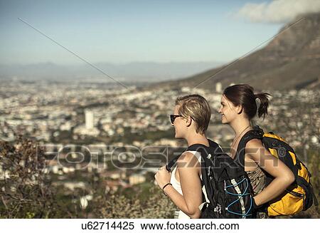 Two young women looking at view from Table Mountain, Cape Town, South Africa View Large Photo Image Stock Photography - Two young women looking at view from Table Mountain, Cape Town, South Africa. Fotosearch