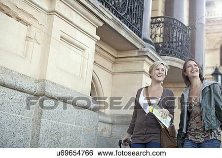 Two young women walking on pavement, Cape Town, South Africa View Large Photo Image Stock Photograph - Two young women walking on pavement, Cape Town, South Africa. Fotosearch