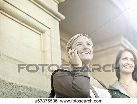 Two young women with mobile phone, Cape Town, South Africa View Large Photo Image Stock Photograph - Two young women with mobile phone, Cape Town, South Africa. Fotosearch