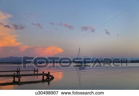 View of yacht at sunset on Lake Starnberg, Bavaria, Germany View Large Photo Image Stock Photo - View of yacht at sunset on Lake Starnberg, Bavaria, Germany. Fotosearch