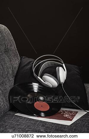 Vinyl records and headphones on armchair View Large Photo Image Stock Image - Vinyl records and headphones on armchair. Fotosearch