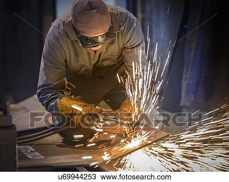 Welder using oxyacetylene torch in factory View Large Photo Image Stock Image - Welder using oxyacetylene torch in factory. Fotosearch