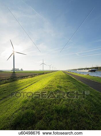 Stock Photograph - Wind turbines and canal, Bath, Zeeland, Netherlands. Fotosearch