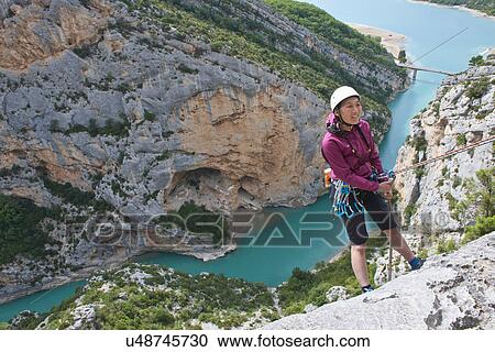 Stock Image - Woman abseiling, Lac de Sainte-Croix, Canyon du Verdon, Provence, France. Fotosearch