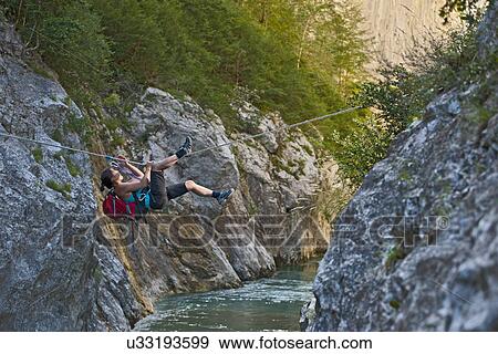 Woman crossing the Verdon gorge on a rope, Couloir du Samson, Canyon du Verdon, Provence, France View Large Photo Image Stock Photo - Woman crossing the Verdon gorge on a rope, Couloir du Samson, Canyon du Verdon, Provence, France. Fotosearch