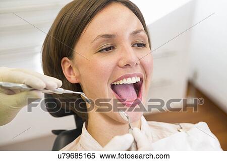 Woman having check up at dentists with mouth open View Large Photo Image Stock Photography - Woman having check up at dentists with mouth open. Fotosearch