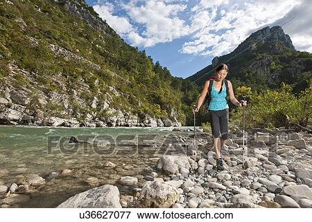 Stock Photo - Woman hiking along the Verdon Canyon, Provence, France. Fotosearch