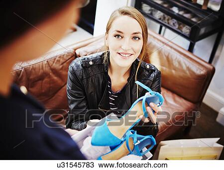 Woman trying on high heeled shoes View Large Photo Image Stock Image - Woman trying on high heeled shoes. Fotosearch